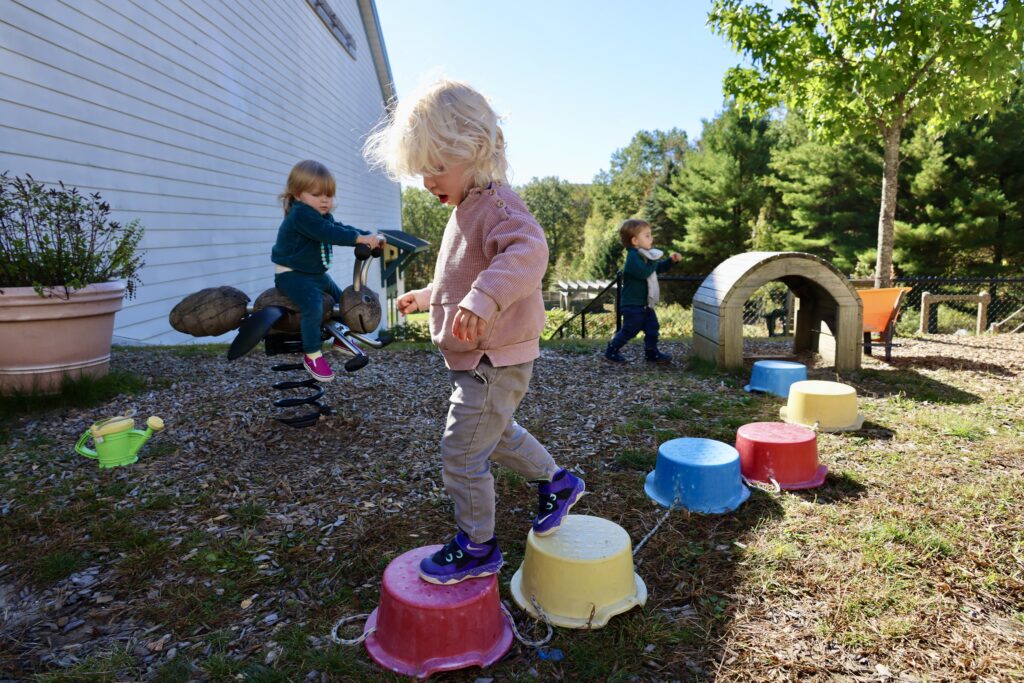 A child walks across an obstacle course