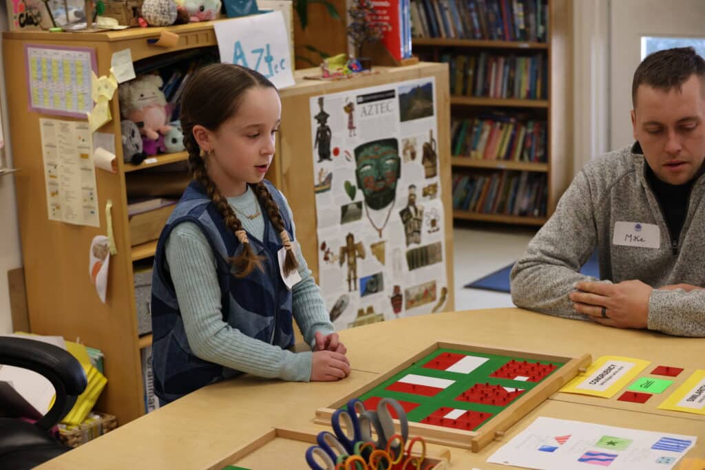 A child works with the Geometric Insets material