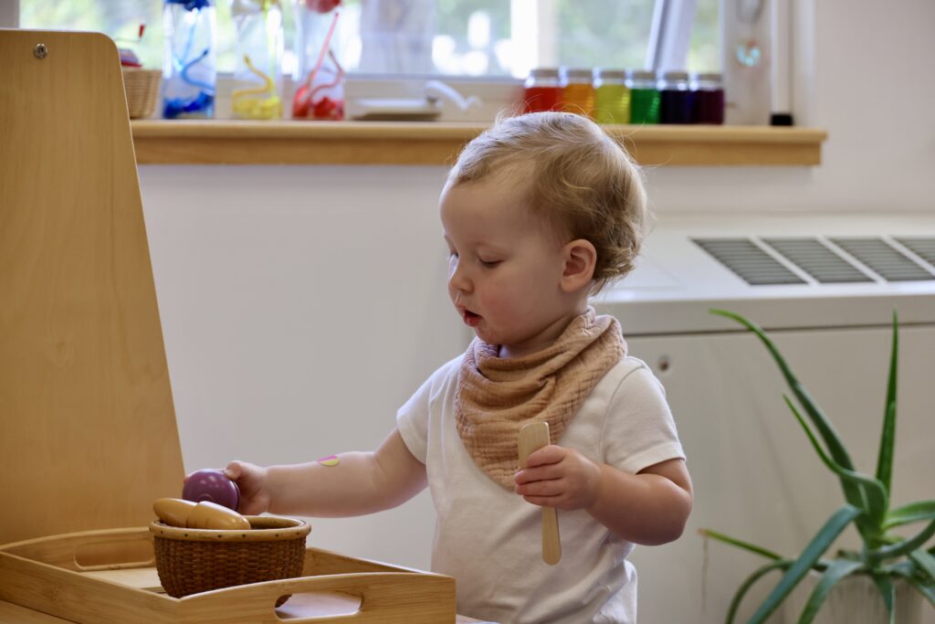 A young child engaged in purposeful, independent work.