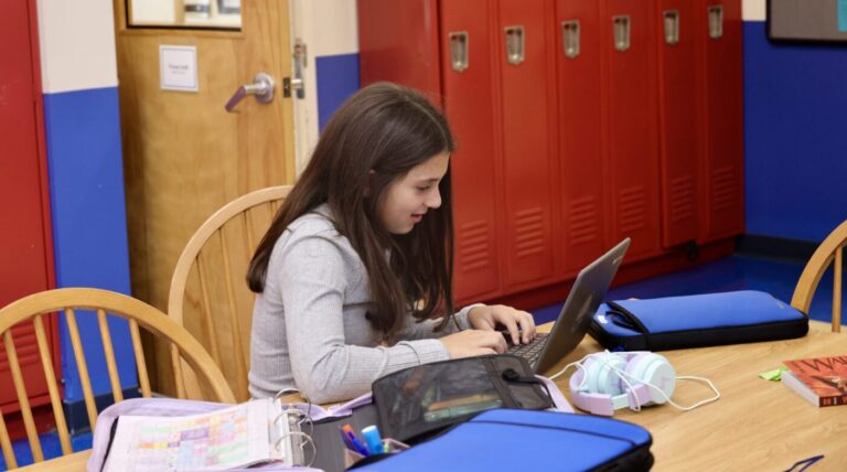 A middle school student works on a computer