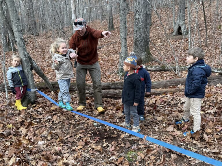 Lower School children participate in a slack line activity during their weekly Nature Program