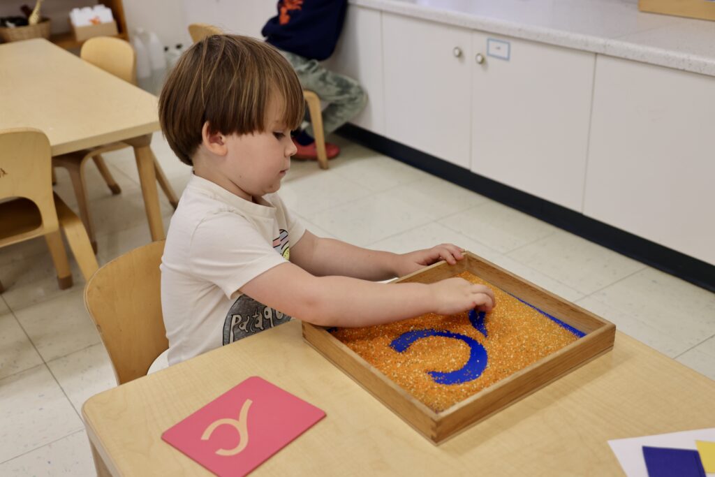 A Lower School student works with the Sandpaper Letters